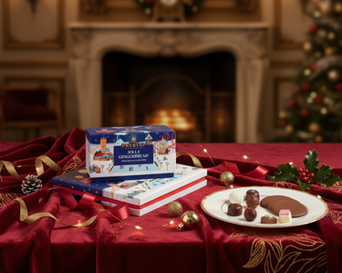 Christmas-themed gingerbread set on a table with festive decorations and a fireplace in the background
