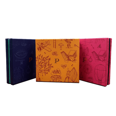 three colorful patterned boxes By Prestat Chocolates