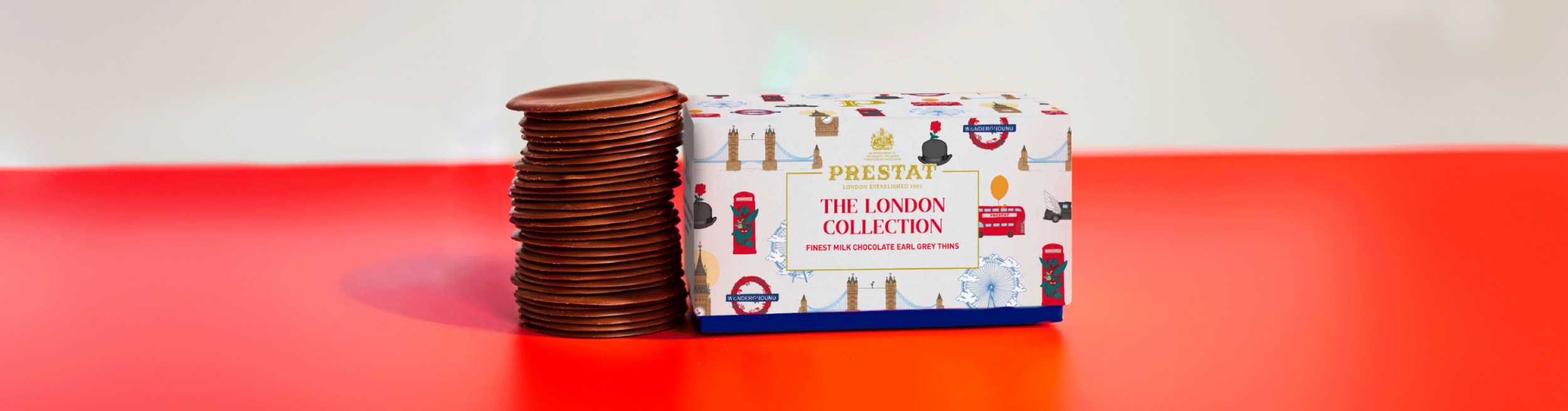 Stack of chocolate coins and a London-themed gift box.