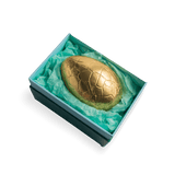 rococo easter egg wrapped in gold foil inside gift box