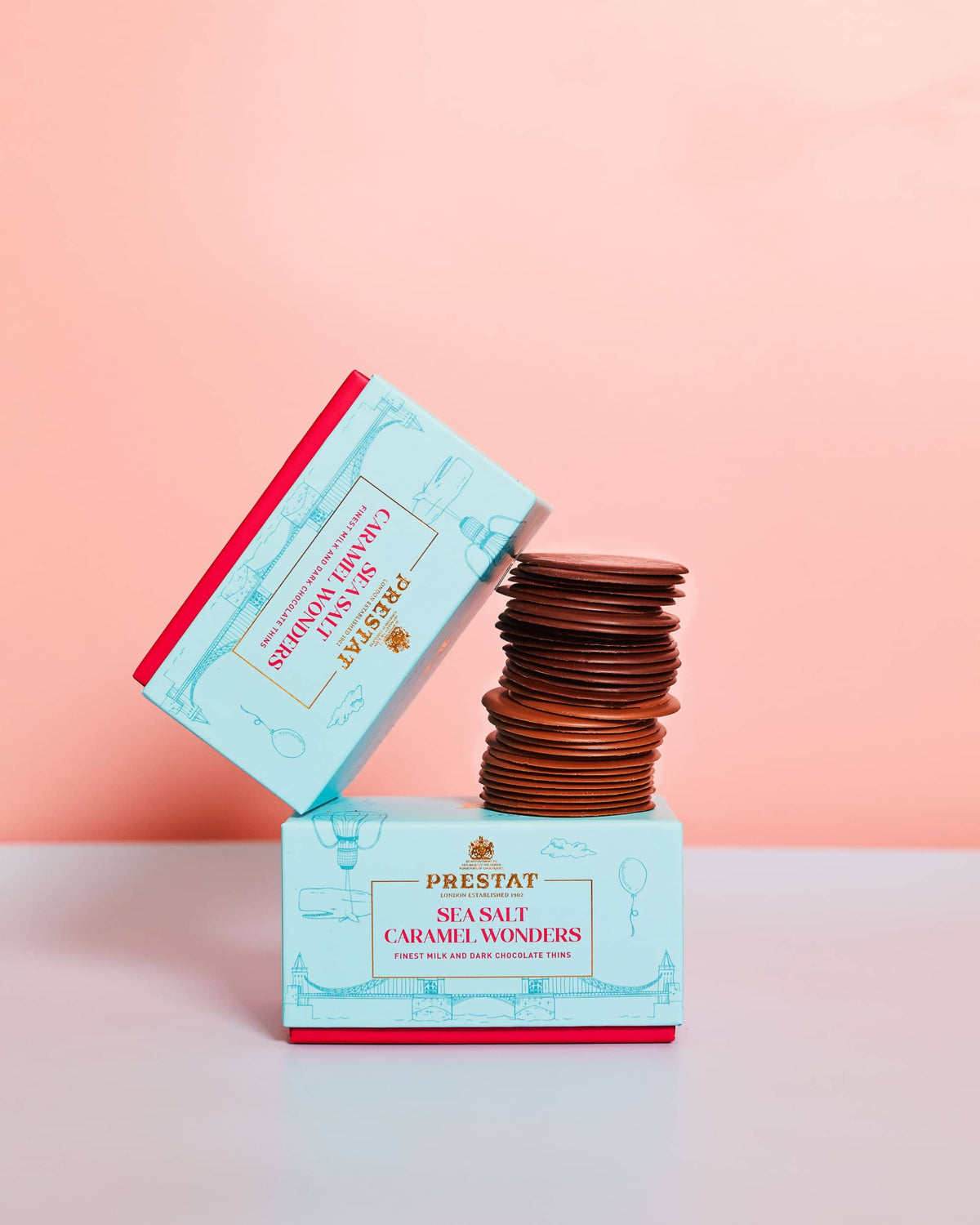 Stacked chocolate caramel rounds with branded packaging.